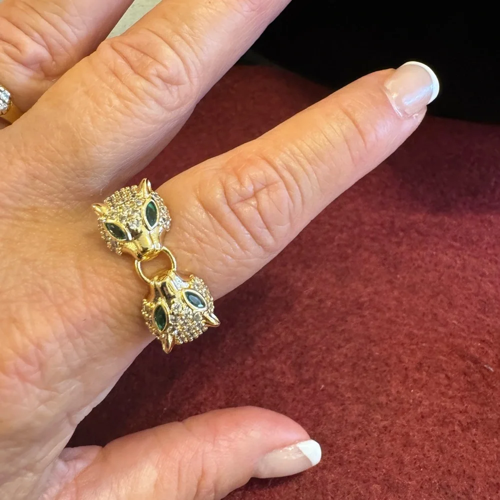 NWOT gold tone double panther ring, encrusted w/CZs & emerald green eyes